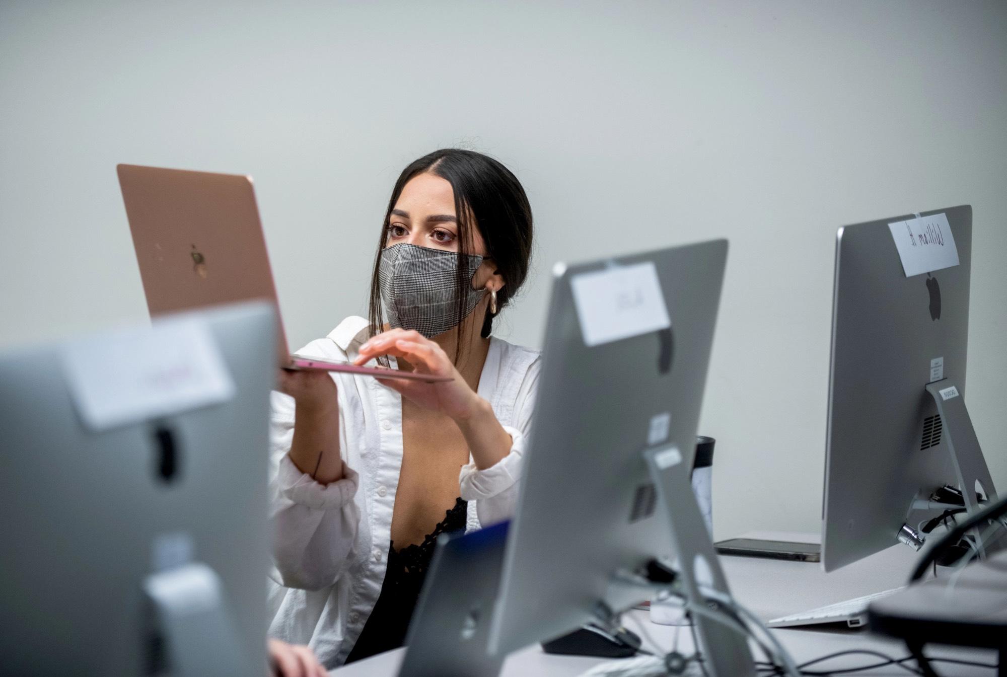 woman surrounded by computers